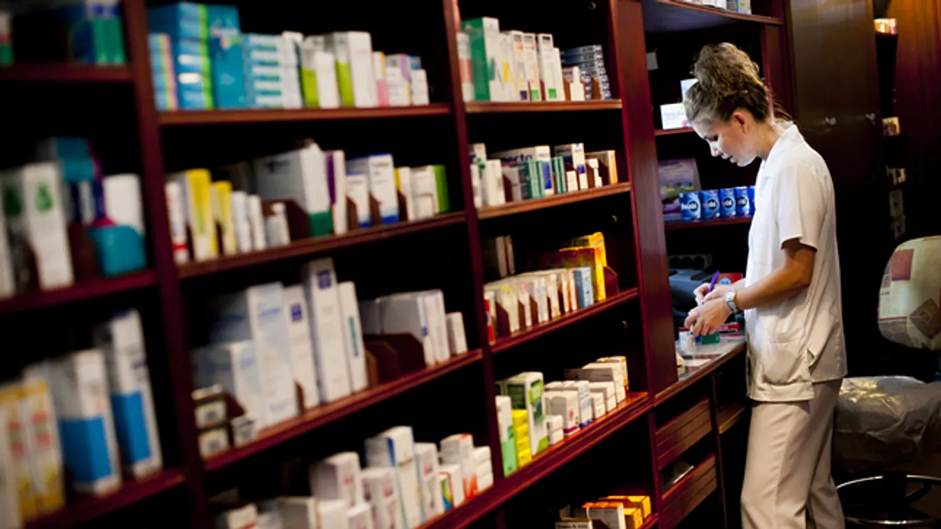 Gyógyszerész áll egy budapesti gyógyszertár kiadóablakában, patika 