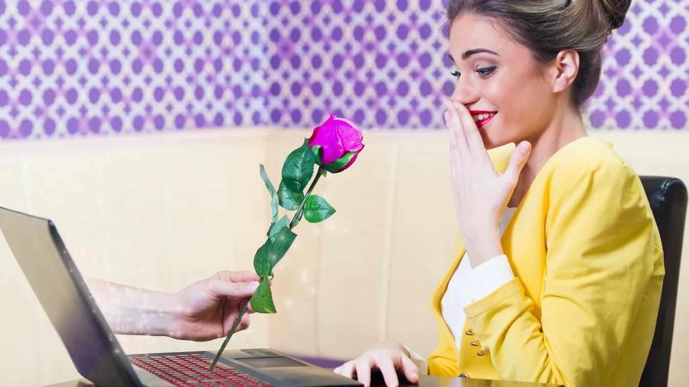 Man offering a rose to a beautiful woman over laptop screen Internet Dating Social Gathering Women Men Love At First Sight Dating Video Conference Camera Flirting Distant Global Communications Valentine's Day E-Mail Message Smiling Talking Giving Fun Meet