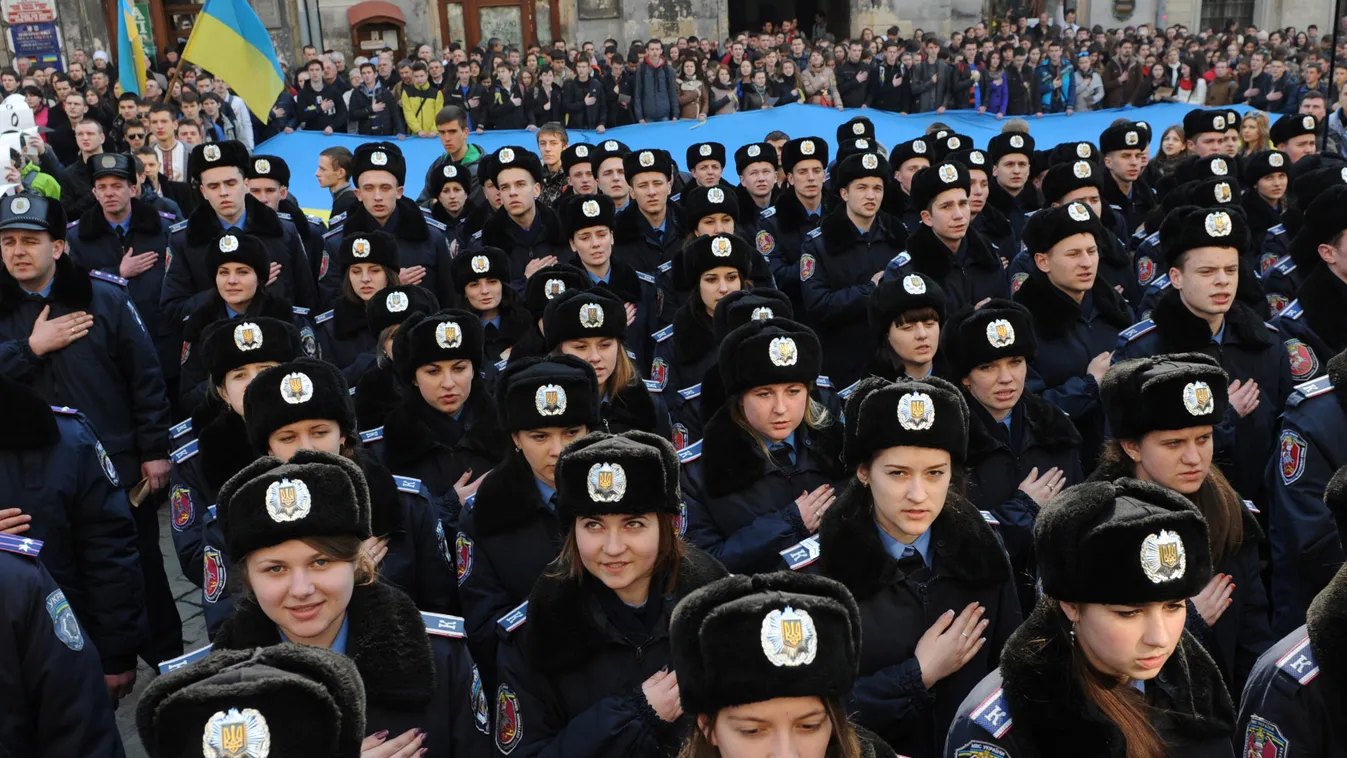 Ukrainian police cadets sing the national anthem during an event in the center of Lviv, western Ukraine on March 10, 2015.  Some 3000 people took part in the event marking the 150th annivertsary of the first rendering of the Nation anthem of Ukraine.  AFP