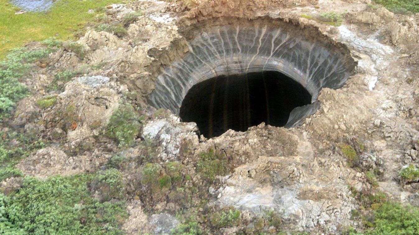HORIZONTAL ILLUSTRATION CRATER TO GO WITH AFP STORY BY ANNA MALPAS
This picture handout on July 26, 2014 by the Press service of the governor of the Yamalo-Nenets region shows a crater located in the permafrost around 30 kilometres (18 miles) from a huge 