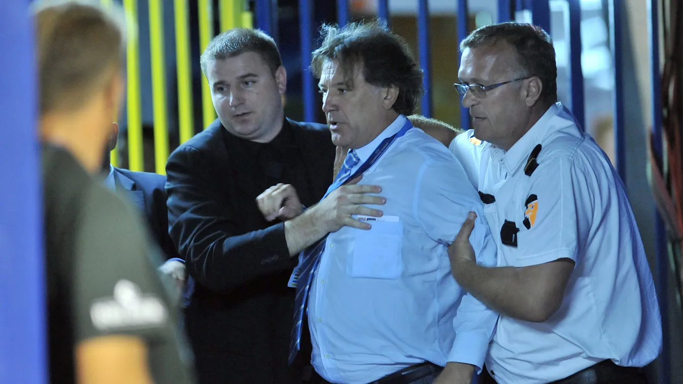 121315731 NK Dinamo Zagreb's executive Zdravko Mamic (C) is held back  by private security agents facing a police officer (not in pic) late August 17, 2011 in Zagreb following his team match vs Malmo. Mamic  was detained overnight after a brawl with polic