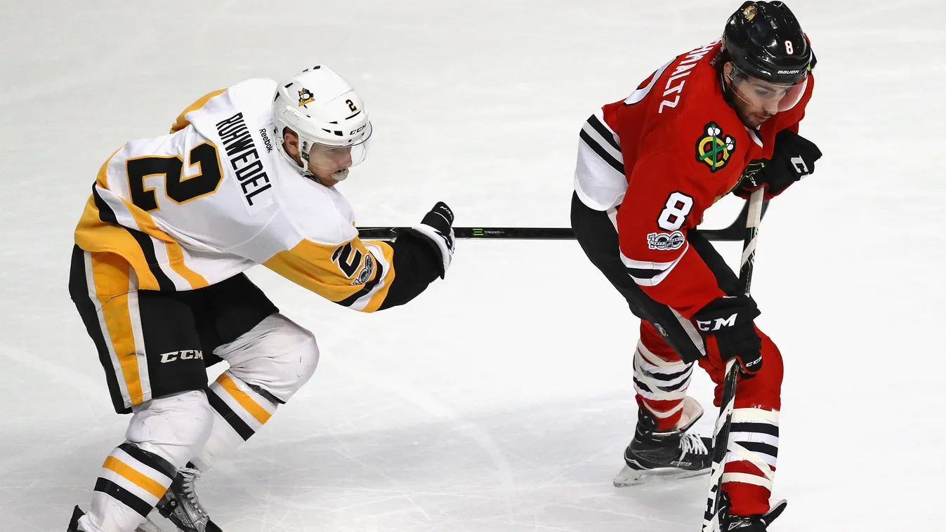 CHICAGO, IL - MARCH 01: Nick Schmaltz #8 of the Chicago Blackhawks controls the puck under pressure from Chad Ruhwedel #2 of the Pittsburgh Penguins at the United Center on March 1, 2017 in Chicago, Illinois. The Blackhawks defeated the Penguins 4-1.   Jo