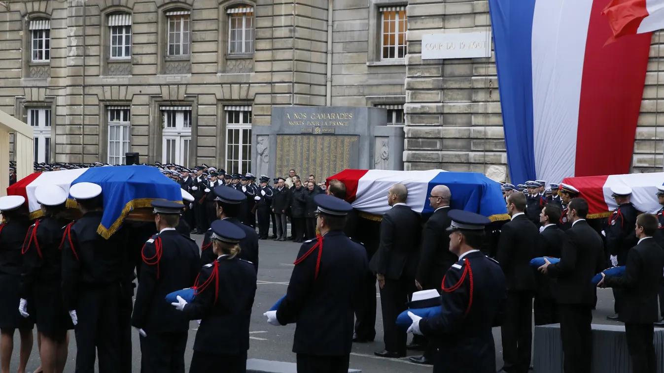 Police officers carry the coffins draped in the French flag of the three Police officers killed in the recent Islamist attacks, on January 13, 2015 in a ceremony to posthumsly decorate them with the Legion d'honneur, at the Paris' prefecture.      AFP PHO