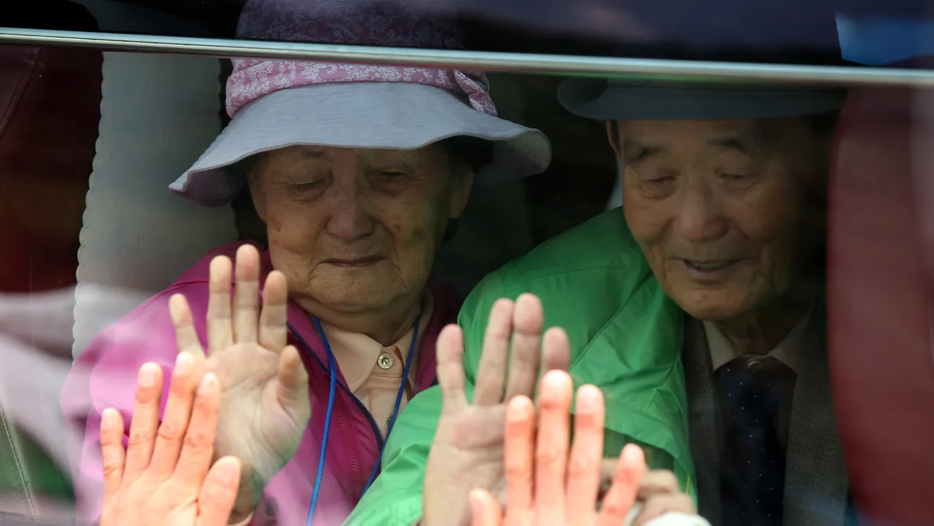 Horizontal South Koreans (on bus) react as they bid farewell through the window to their North Korean relatives after a three-day family reunion event at North Korea's Mount Kumgang resort on October 26, 2015.  North and South Korean families divided sinc