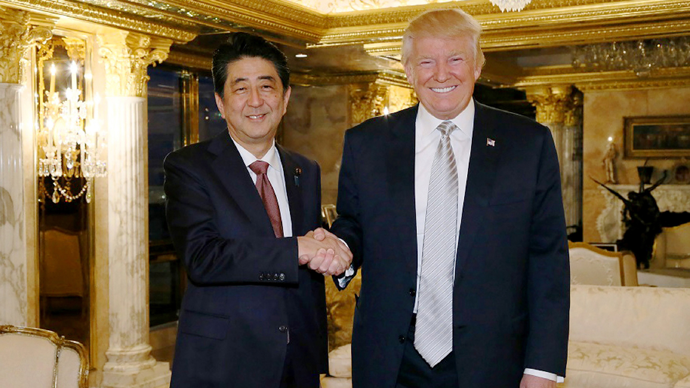 Horizontal This handout picture from Japan's Cabinet Secretariat released on November 18, 2016 shows Japan's Prime Minister Shinzo Abe (L) shaking hands with US President-elect Donald Trump in New York.
Abe voiced confidence on November 17 about Trump as 