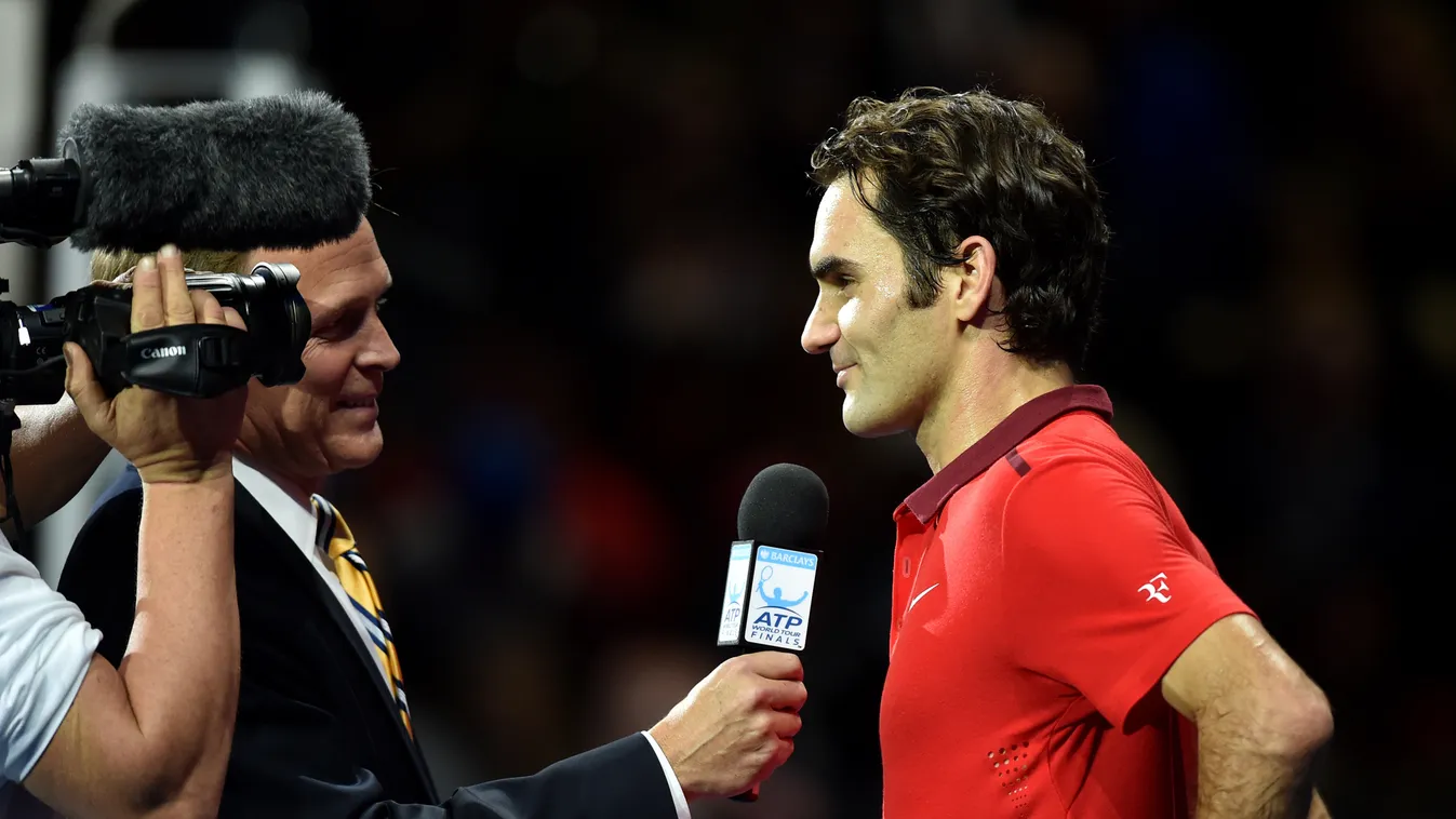 Switzerland's Rodger Federer is interviewed after winning his Group B singles match against Britain's  Andy Murray on day five of the ATP World Tour Finals tennis tournament in London on November 13, 2014. Federer won 6-0, 6-1. AFP PHOTO/LEON NEAL 