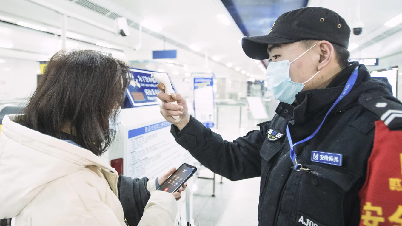 Vuhan, 2020. január 23.
A Hszinhua kínai állami hírügynökség által közreadott képen egy utas testhőmérsékletét méri a metró egyik dolgozója Vuhanban 2020. január 23-án. Négyszáz fölé nőtt az új koronavírussal fertőzöttek száma Kínában, ahol a járvány már 