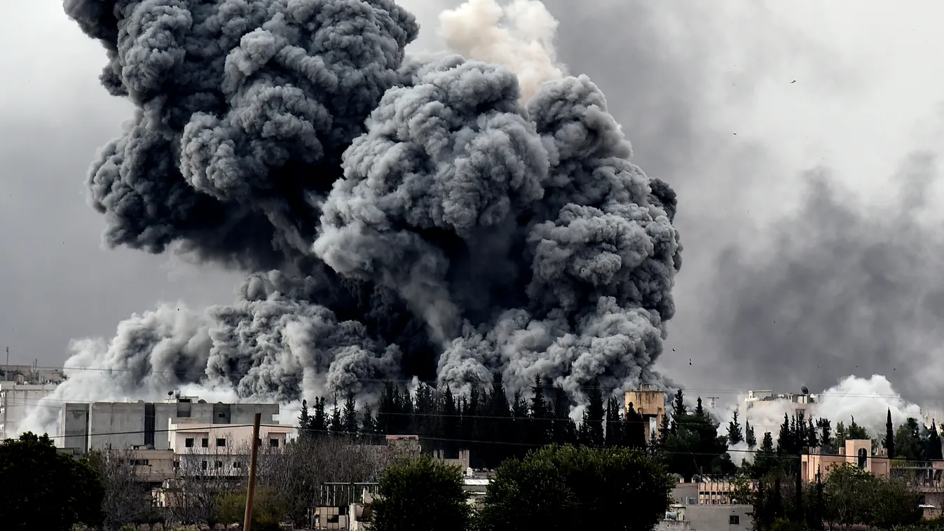 HORIZONTAL Smoke rises after a strike on the Syrian town of Ain al-Arab, known as Kobane by the Kurds, as seen from the Turkish-Syrian border,  in the southeastern village of Mursitpinar, Sanliurfa province, on October 12, 2014. Kurds are furious that Tur