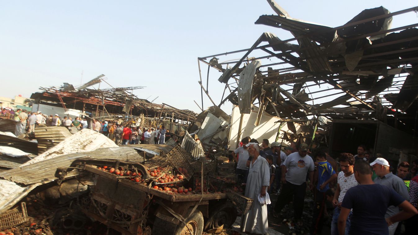 Iraqi men look at the damage following a bomb explosion that targeted a vegetable market in Baghdad's northern Shiite district of Sadr City on August 13, 2015. The truck bombing claimed by the Islamic State group killed at least 38 people in the Shiite-ma