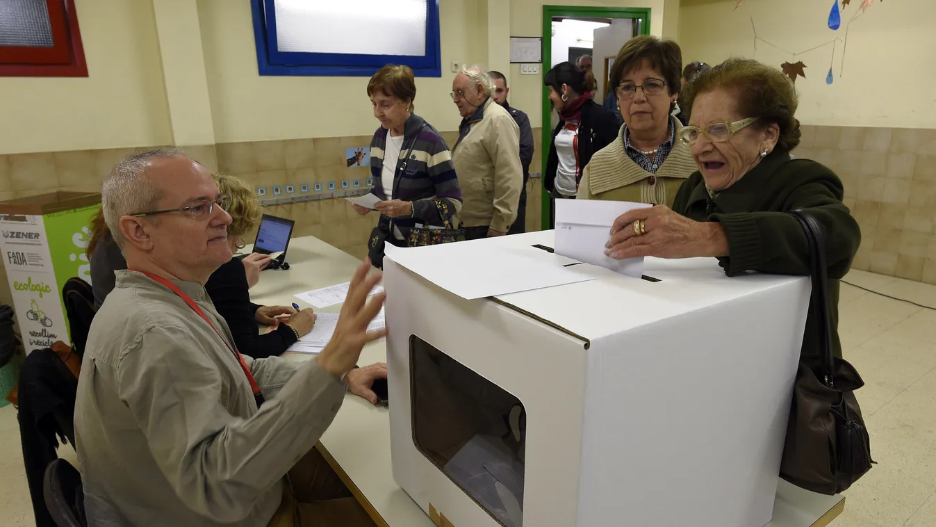 People cast their ballots on November 9, 2014 in a school in Barcelona to vote in a symbolic ballot on whether to break away as an independent state, defying fierce challenges by the Spanish government. One of Spain's richest but most indebted regions, Ca