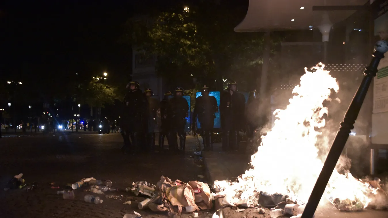 Policemen behing a fire during the clashes 10 juillet 10 july CRS EURO UEFA UEFA EURO 2016 celebrating celebrer CHAMPS ELYSEES clash clashes CONFRONTATION echauffourées feu d'artifice finale fire FOOTBALL franpor heurts paris police portugal supporter ten
