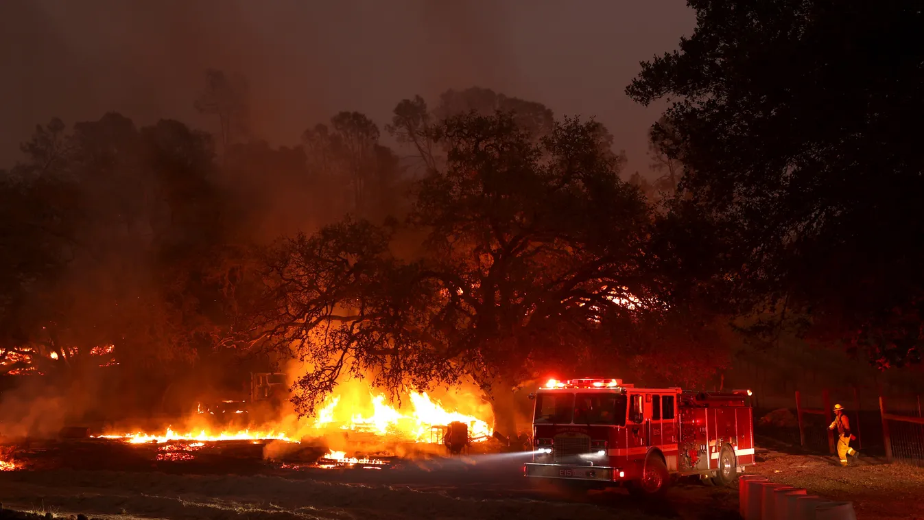 GettyImageRank2 Color Image HORIZONTAL accidents and disasters CALISTOGA, CALIFORNIA - OCTOBER 01: A Contra Costa County fire truck moves by burning building materials while battling the Glass Fire on October 01, 2020 in Calistoga, California. The fast mo