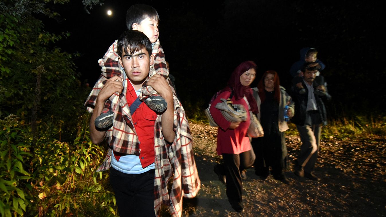 Migrants walk toward the Croatian-Hungarian border during night after arriving at the railway station of Botovo, on September 22, 2015. Hungary has emerged this year as a "frontline" state in Europe's migrant crisis, with 225,000 travelling up from Greece