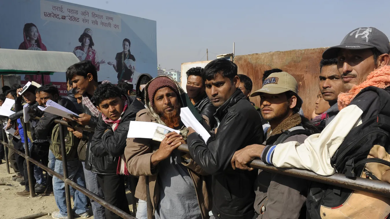 Nepalese migrant workers queue to receive official documents in order to leave Nepal from the Labour department in Kathmandu on January 27, 2014.  Nearly 200 Nepali migrant workers died in Qatar in 2013, many of them from heart failure, officials said, fi