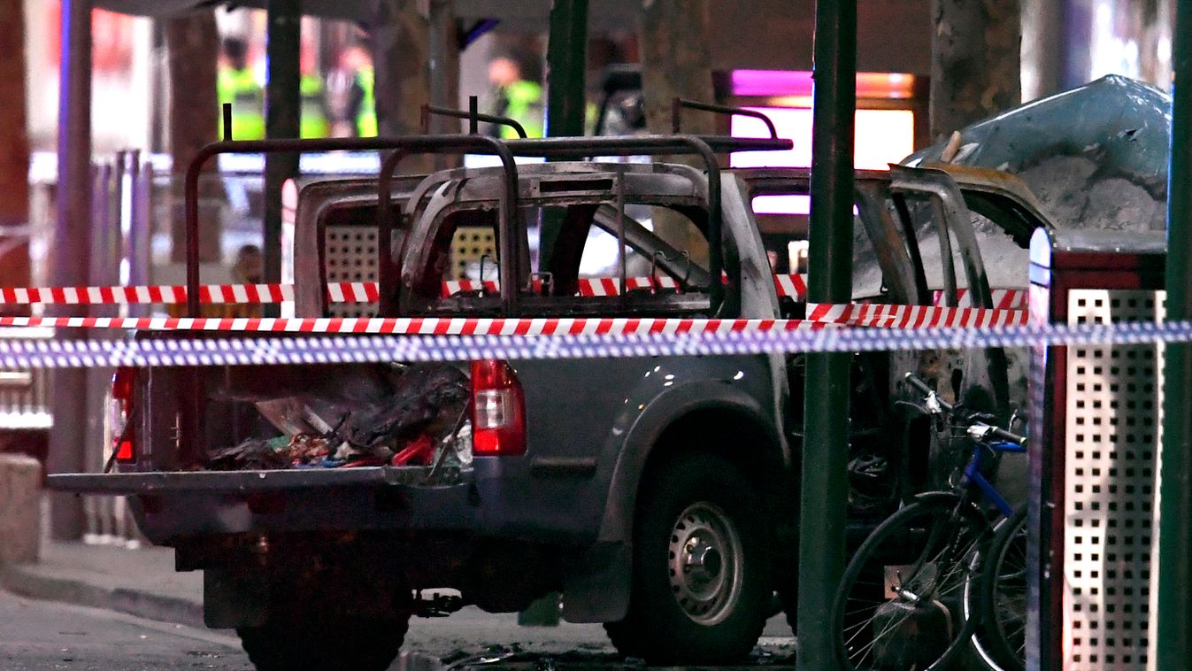 Horizontal A burnt out vehicle is pictured at the crime scene following a stabbing incident in Melbourne on November 9, 2018. - One person was killed and two others injured in a rush hour stabbing incident in Melbourne's bustling central business district