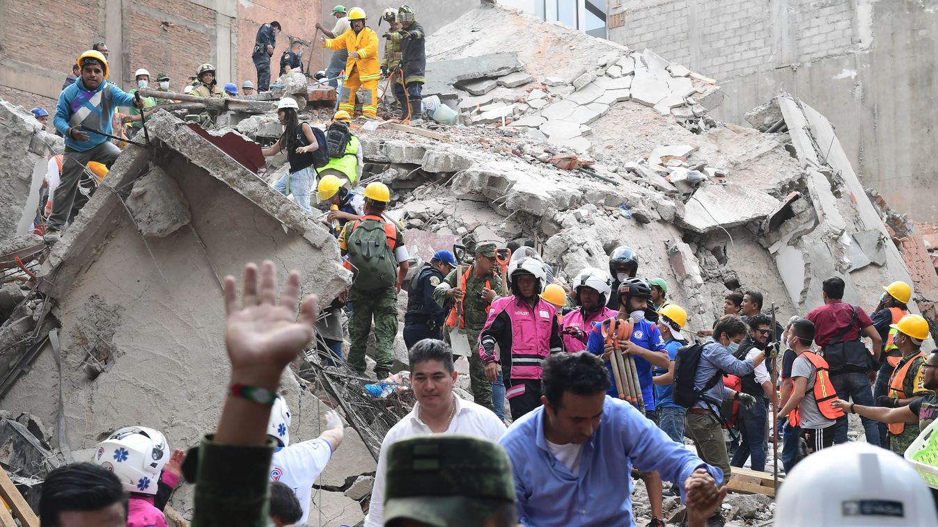 Horizontal Rescuers, firefighters, policemen, soldiers and volunteers remove rubble and debris from a flattened building in search of survivors after a powerful quake in Mexico City on September 19, 2017.
A devastating quake in Mexico on Tuesday killed mo