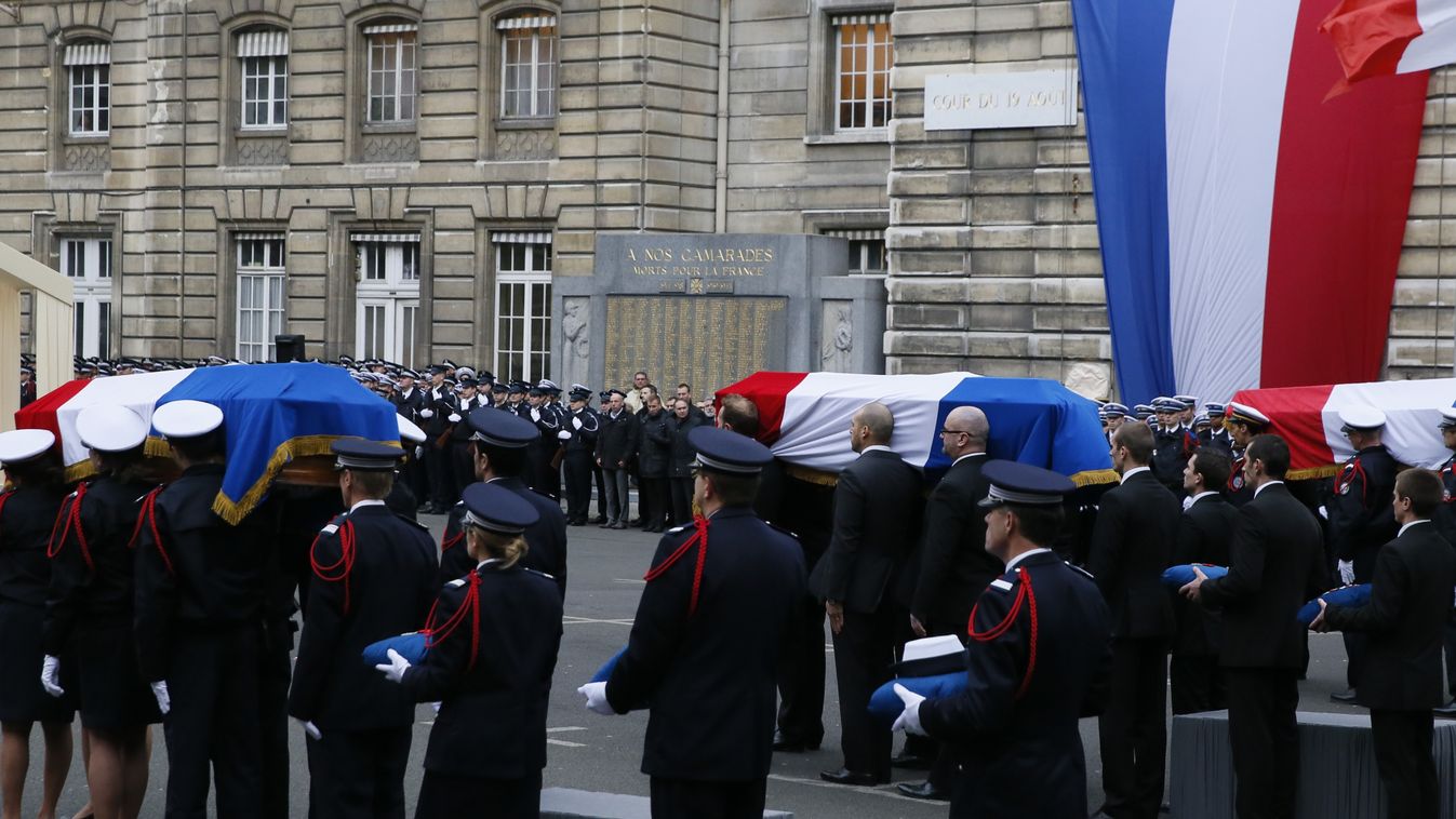 Police officers carry the coffins draped in the French flag of the three Police officers killed in the recent Islamist attacks, on January 13, 2015 in a ceremony to posthumsly decorate them with the Legion d'honneur, at the Paris' prefecture.      AFP PHO