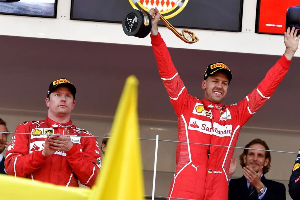 Horizontal Winner Ferrari's German driver Sebastian Vettel (R) celebrates on the podium next to second placed Ferrari's Finnish driver Kimi Raikkonen after the Monaco Formula 1 Grand Prix at the Monaco street circuit, on May 28, 2017 in Monaco.  / AFP PHO