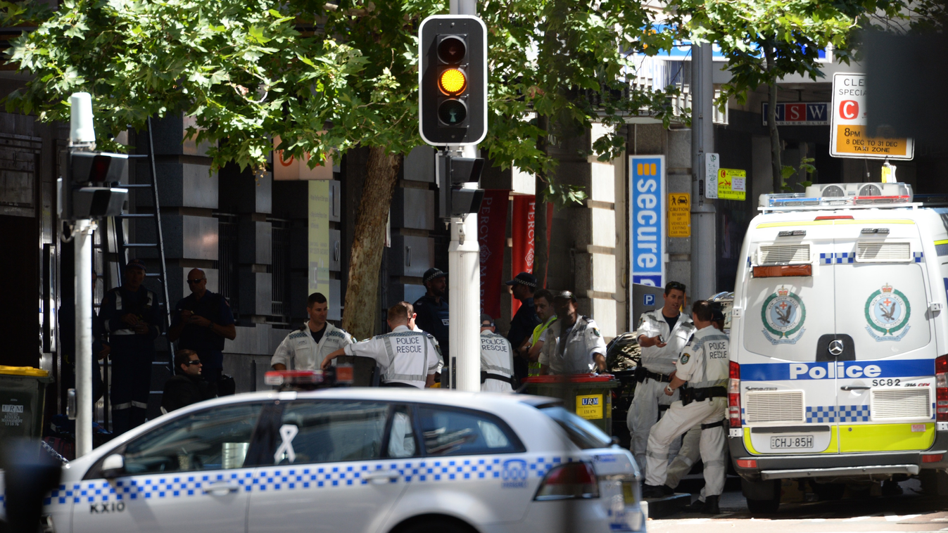 A police rescue squad is seen near a cafe in the central business district of Sydney on December 15, 2014. A gunman was holding terrified hostages inside a Sydney cafe December 15 with an Islamic flag displayed at the window, triggering a lockdown in an a