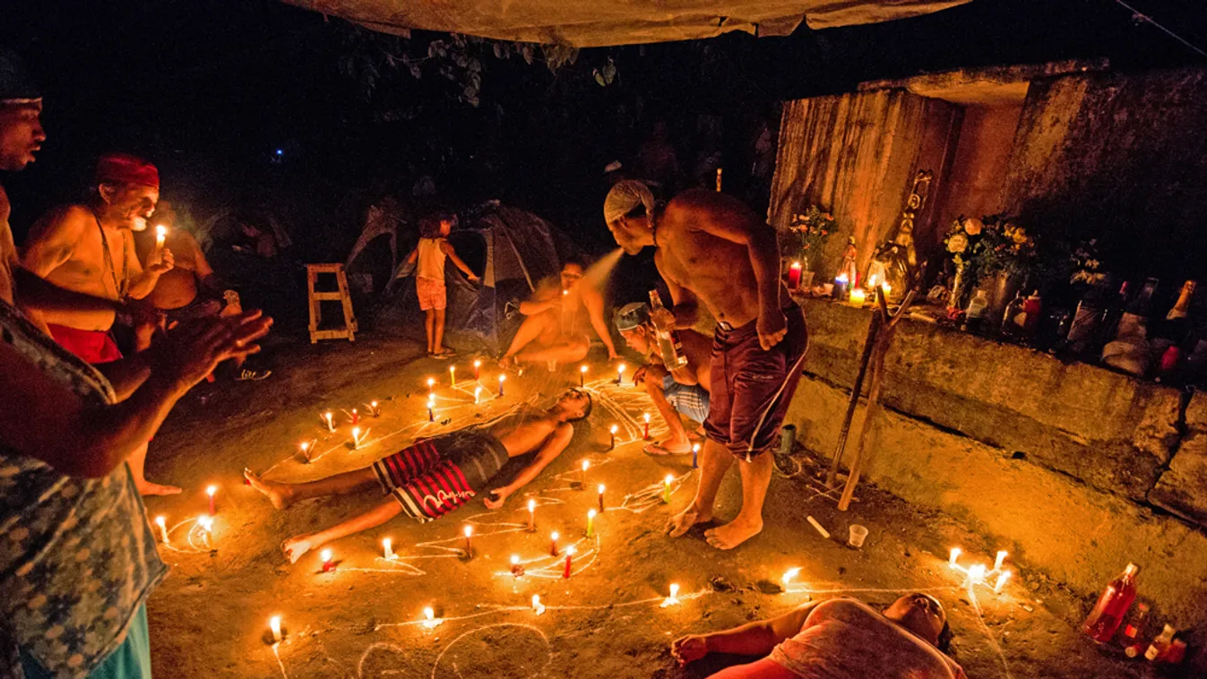 TOPSHOTS
People take part in a spiritual ceremony in the mountains of Sorte in Yaracuy, west of Caracas on October 12, 2014. Santeria and Spiritualism is a popular belief in Venezuela, which mixes African and Catholic deities. On October 12, Day of Indige