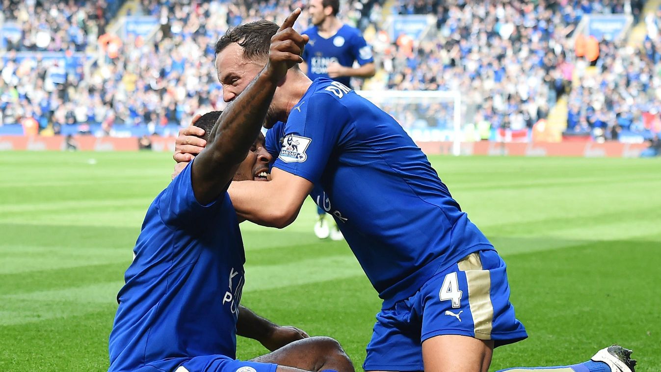 Leicester City's English defender Wes Morgan (L) celebrates with Leicester City's English midfielder Danny Drinkwater after scoring during the English Premier League 
