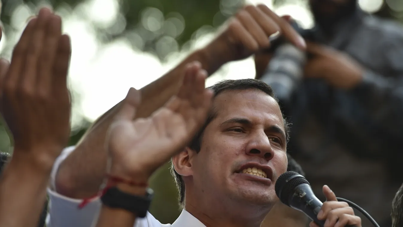 Horizontal Venezuelan opposition leader and self-proclaimed interim president Juan Guaido speaks during a rally in San Bernardino neighbourhood in Caracas on April 1, 2019. - Venezuela's top court -the Supreme Court of Justice- called on the ruling Consti