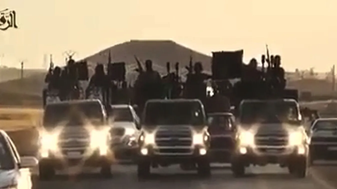 Horizontal An image grab taken from a video released by Islamic State group's official Al-Raqqa site via YouTube on September 23, 2014, allegedly shows Islamic State (IS) group recruits riding in armed trucks in an unknown location. The US-led coalition l