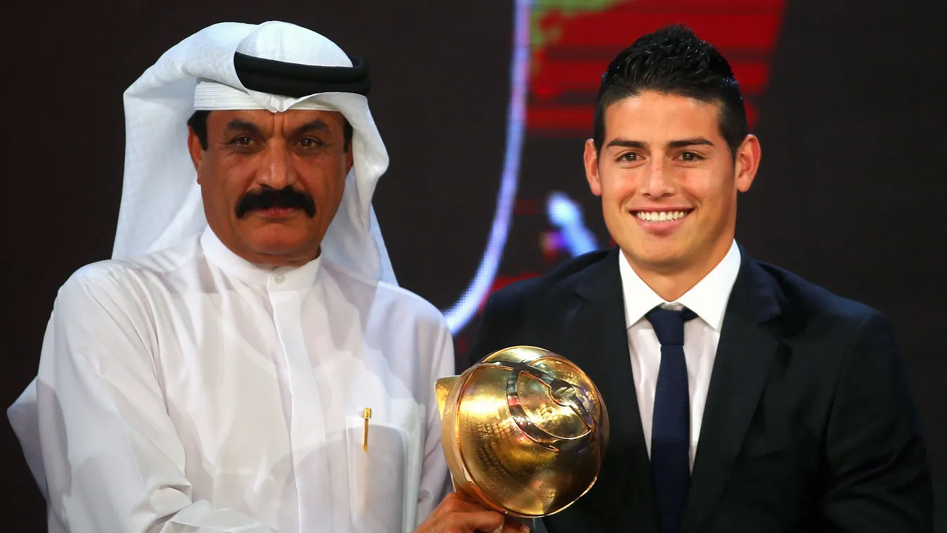 HORIZONTAL FOOTBALL GALA RECEPTION SPORTS AWARD PORTRAIT Real Madrid football club's player James  Rodriguez (R) receives his "Revelation of the Year" award from Dubai police chief Khmais al-Muzaiha during the Globe Soccer Awards Ceremony at the end of th