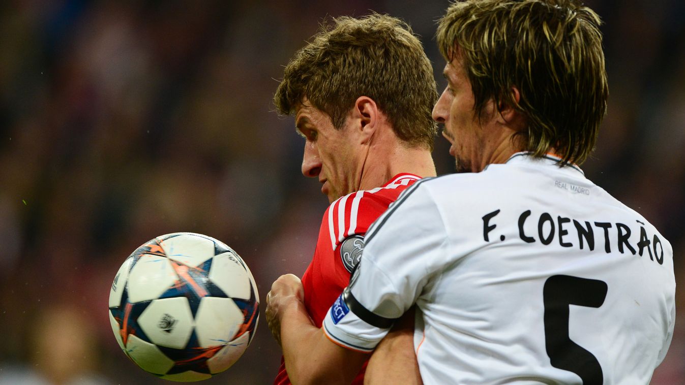 485511243 Bayern Munich's midfielder Thomas Mueller (L) and Real Madrid's Portuguese defender Fabio Coentrao vie for the ball during the UEFA Champions League second-leg semi-final football match FC Bayern Munich vs Real Madrid CF in Munich, southern Germ