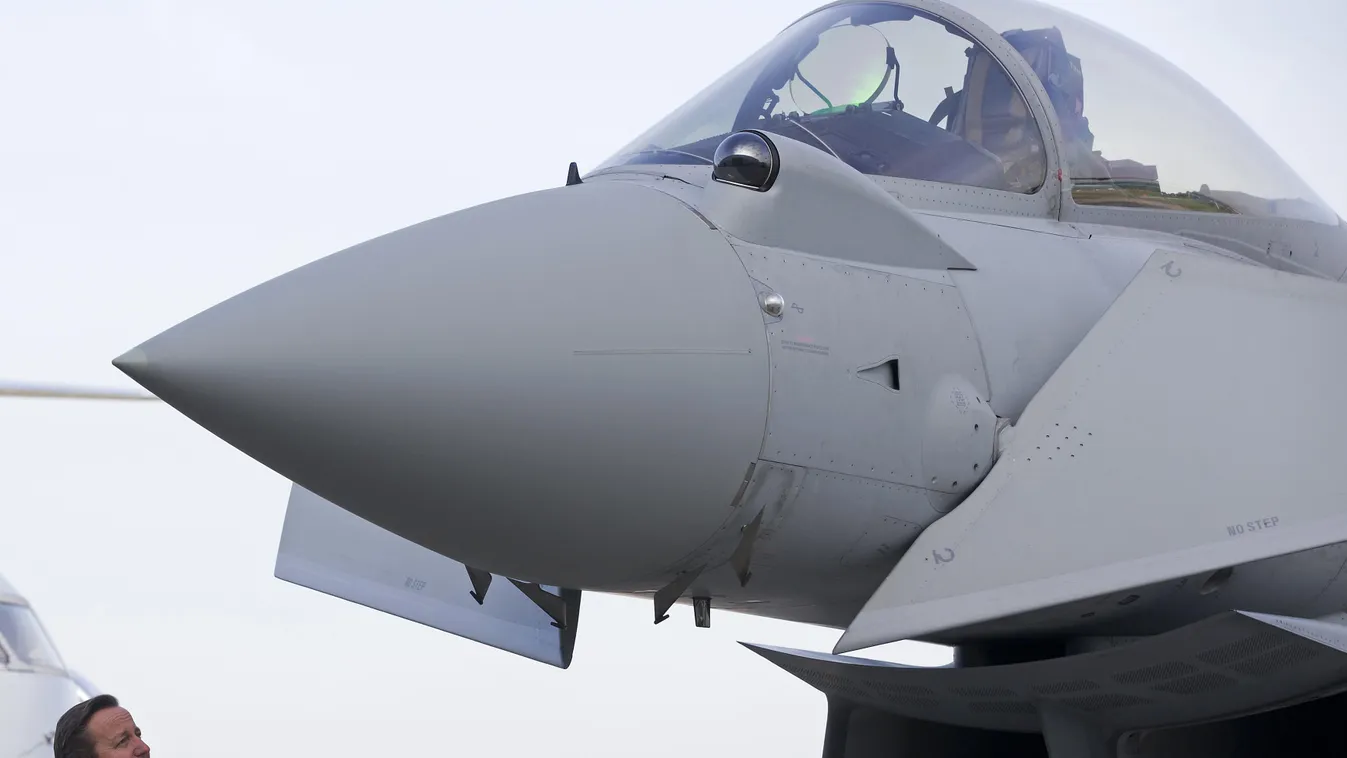 British Prime Minister David Cameron looks at an RAF Eurofighter Typhoon fighter jet during his visit to Royal Air Force station RAF Northolt, in west London on November 23, 2015, before presenting his government's Strategic Defence and Security Review (S