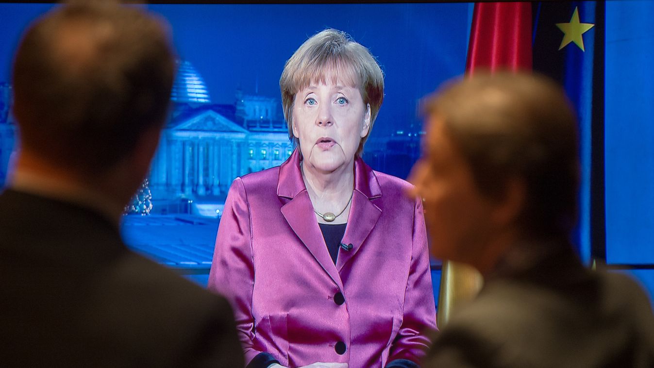 "EMBARGO DECEMBER 31, 2014, 00:01: FREE FOR NEWSPAPERS' EDITIONS FROM DECEMBER 31, 2014 AND FOR ONLINE USE FROM DECEMBER 31, 2014, 00:01"
Employees of the chancellery and tv crew watch on a screen as German Chancellor Angela Merkel records her annual New 
