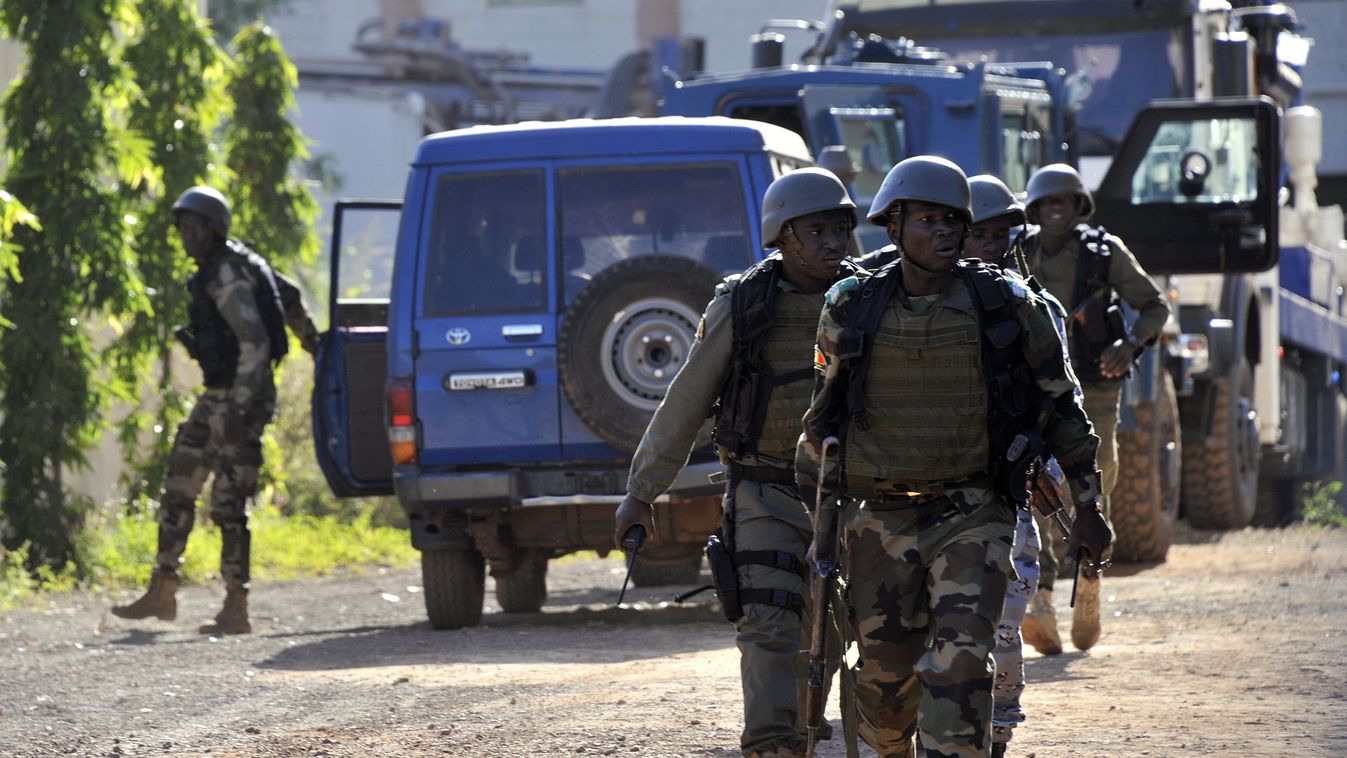 Horizontal Malian troops take position near the Radisson Blu hotel in Bamako on November 20, 2015. Gunmen went on a shooting rampage at the luxury hotel in Mali's capital Bamako, seizing 170 guests and staff in an ongoing hostage-taking that has left at l