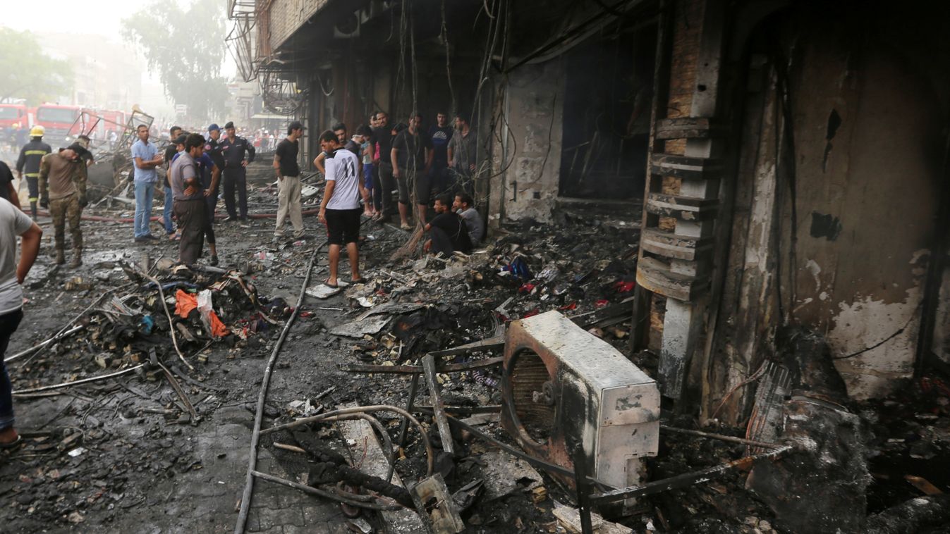 Horizontal Iraqis inspect the damage at the site of a suicide car bombing claimed by the Islamic State group on July 3, 2016 in Baghdad's central Karrada district.
The blast, which ripped through a street in the Karrada area where many people go to shop a