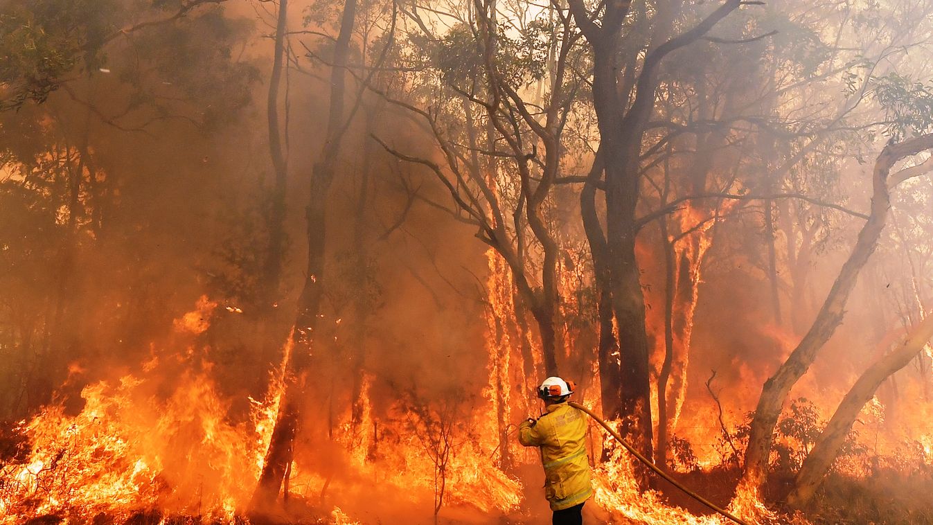 fire climate Horizontal This photo taken on December 10, 2019 shows a firefighter conducting back-burning measures to secure residential areas from encroaching bushfires in the Central Coast, some 90-110 kilometres north of Sydney. - Toxic haze blanketed 