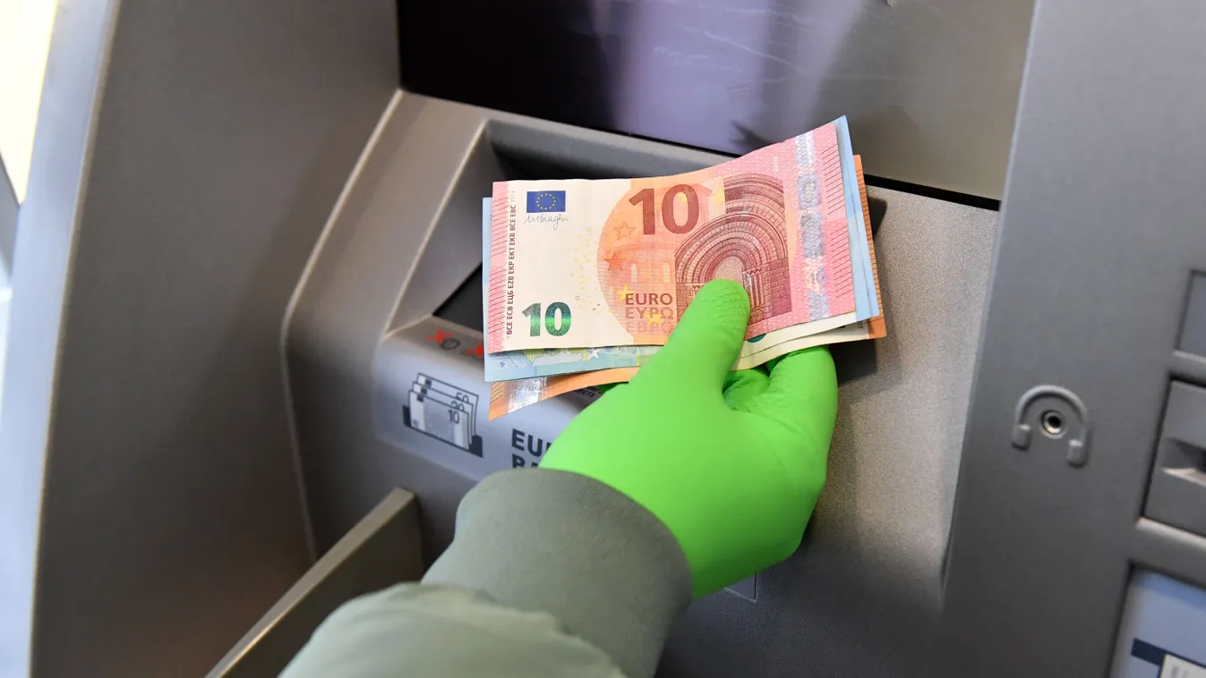 Withdraw cash at ATM with protective gloves. banknotes cash payment VM closure closed corona crisis AUTOMATIC TELLER MACHINE ECONOMIC CRISIS corona withdraw BANK pandemic protective measure Receipt ECONOMY database REST downturn recession crisis credit in