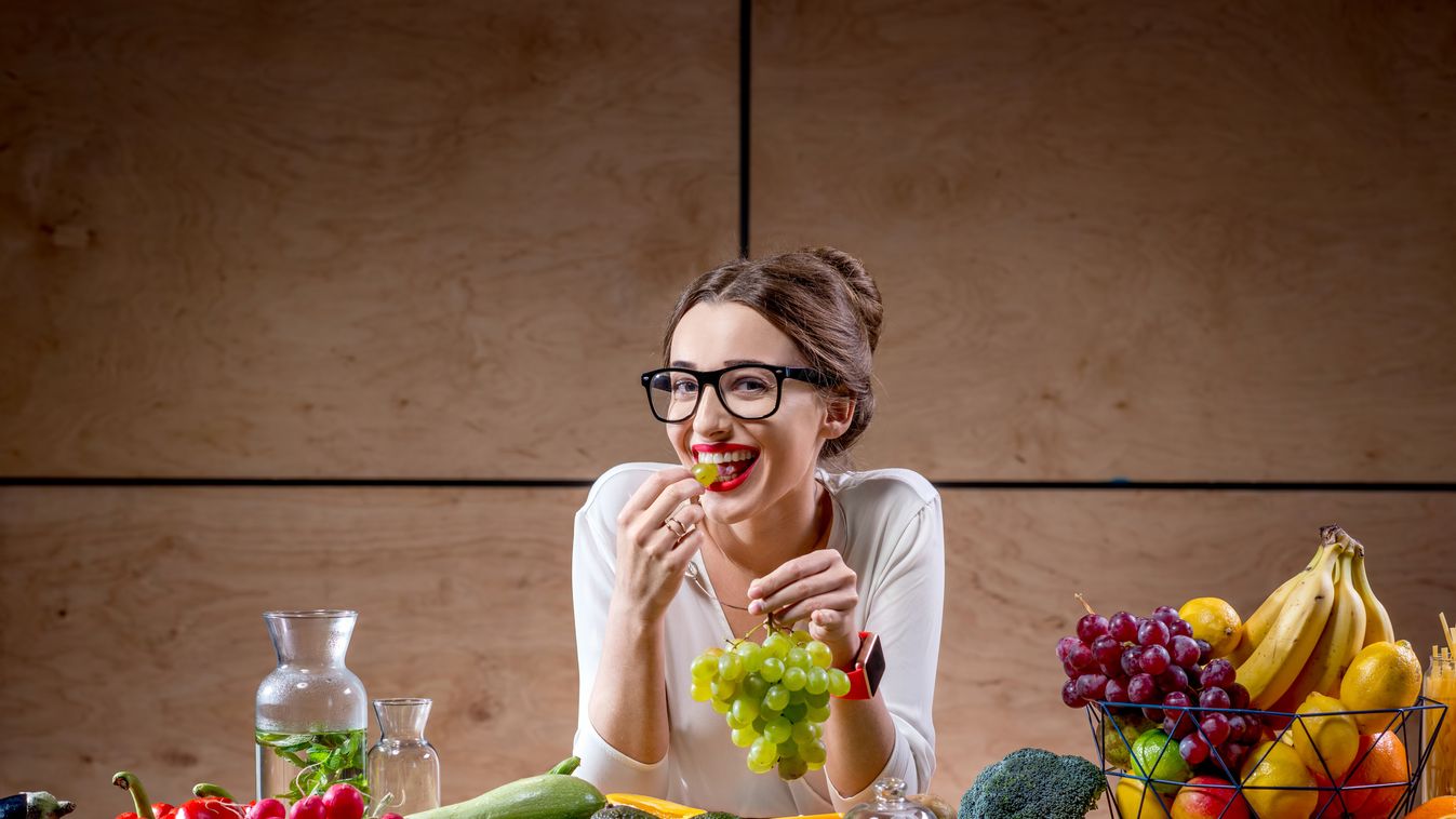 Young woman with fruits and vegetables in the kitchen Beautiful Vitamin Body Care Healthy Eating Wellbeing Girls Women Females Large Group of Objects Dieting Vegetarian Food Smiley Face Raw Food Organic Cute 20-29 Years Young Adult Adult Smiling Eating In