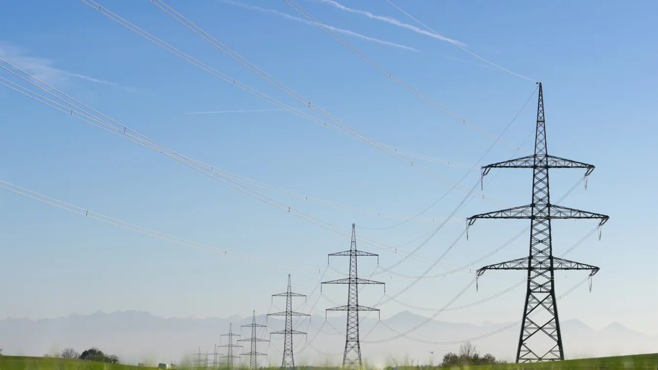 Transmission towers and overhead electrical power lines with mountain range, Bavaria, Germany infrastructure energy power transmission tower electric power transmission tower high voltage power electric power transmission overhead power lines 