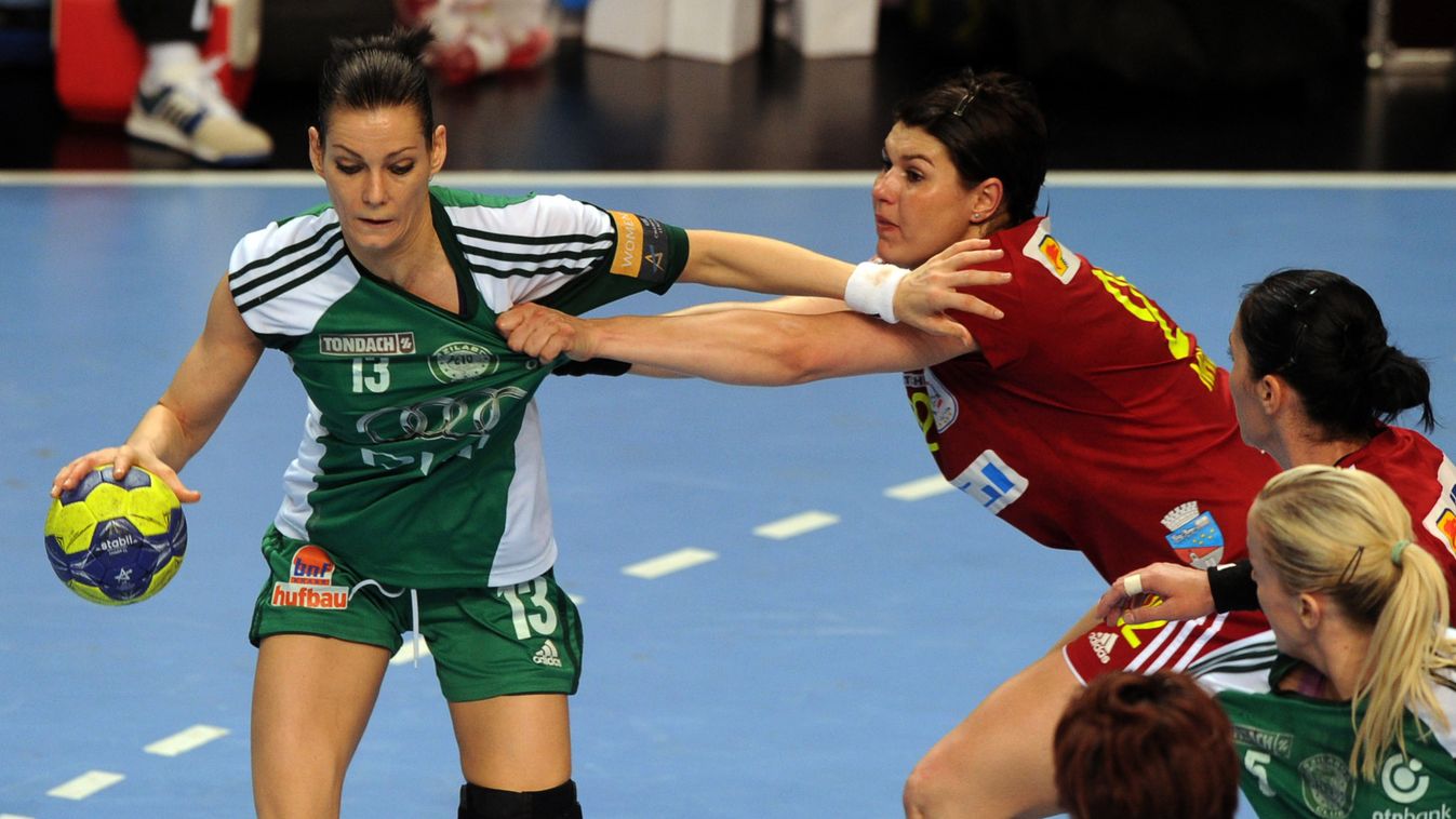 HORIZONTAL Hungarian Anita Gorbicz (L) of KC AUDI-ETO Gyor is fouled by  Romanian Oana Manea (R) of Oltcim RM Valcea in the local sports hall of Veszprem on April 11, 2013 during their EHF Champions League handball match for final.  AFP PHOTO / ATTILA KIS