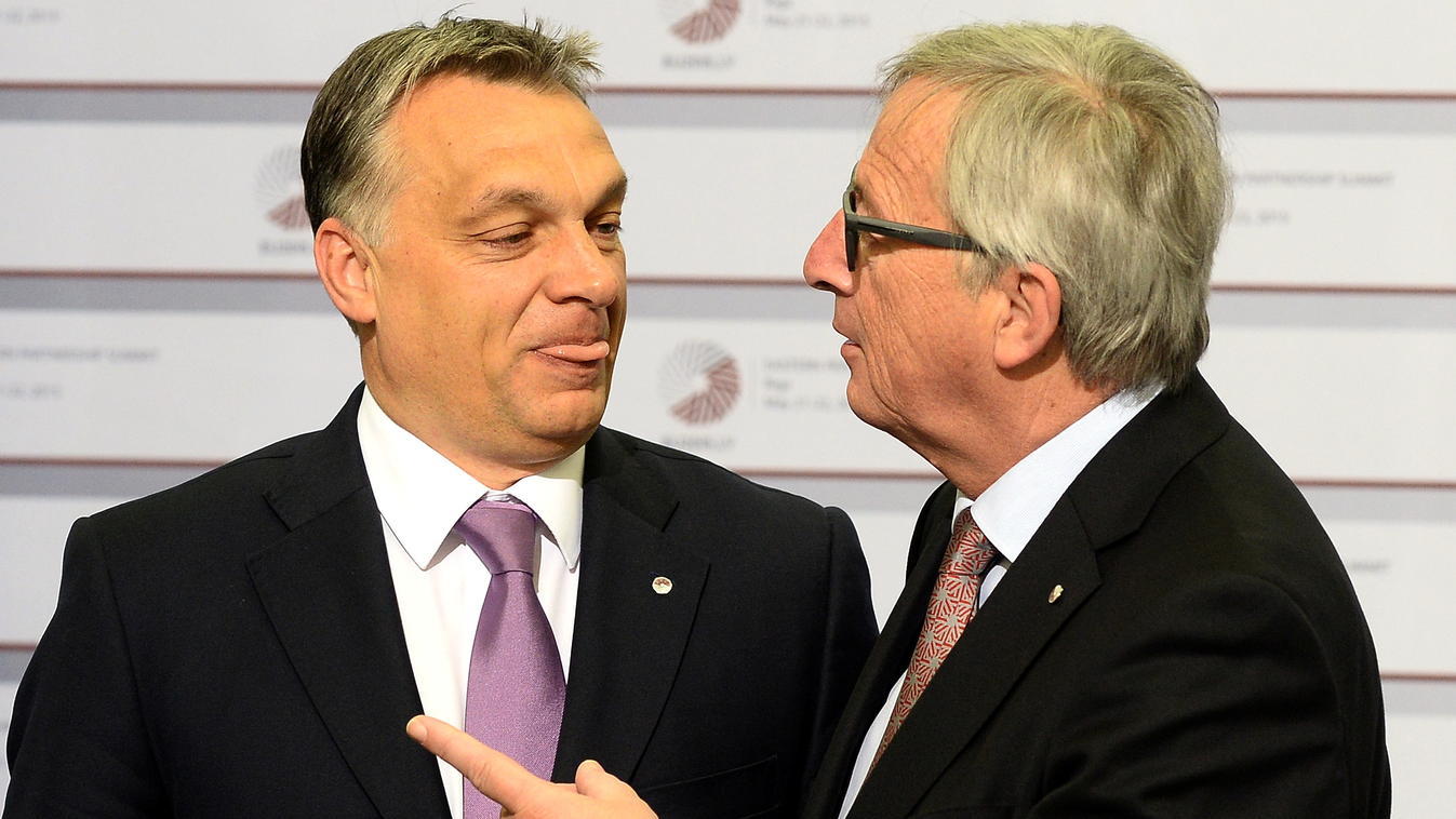 Hungarian Prime Minister Viktor Orban is greeted by President of the European Commission Jean-Claude Juncker on the second day of the fourth European Union (EU) eastern Partnership Summit in Riga, on May 22, 2015 as Latvia holds the rotating presidency of