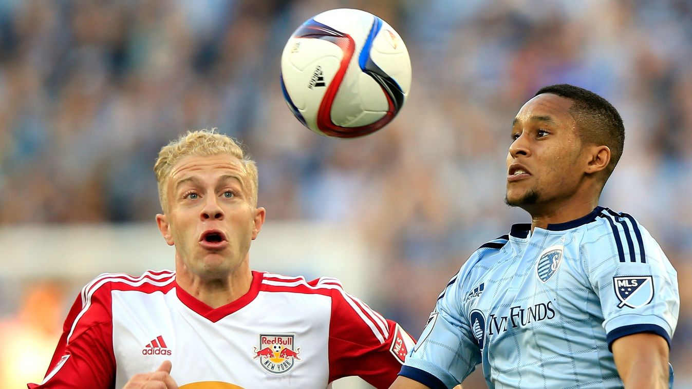 Amadou Dia #13 of Sporting KC battles Mike Grella #13 of the New York Red Bulls for a head ball during the game 