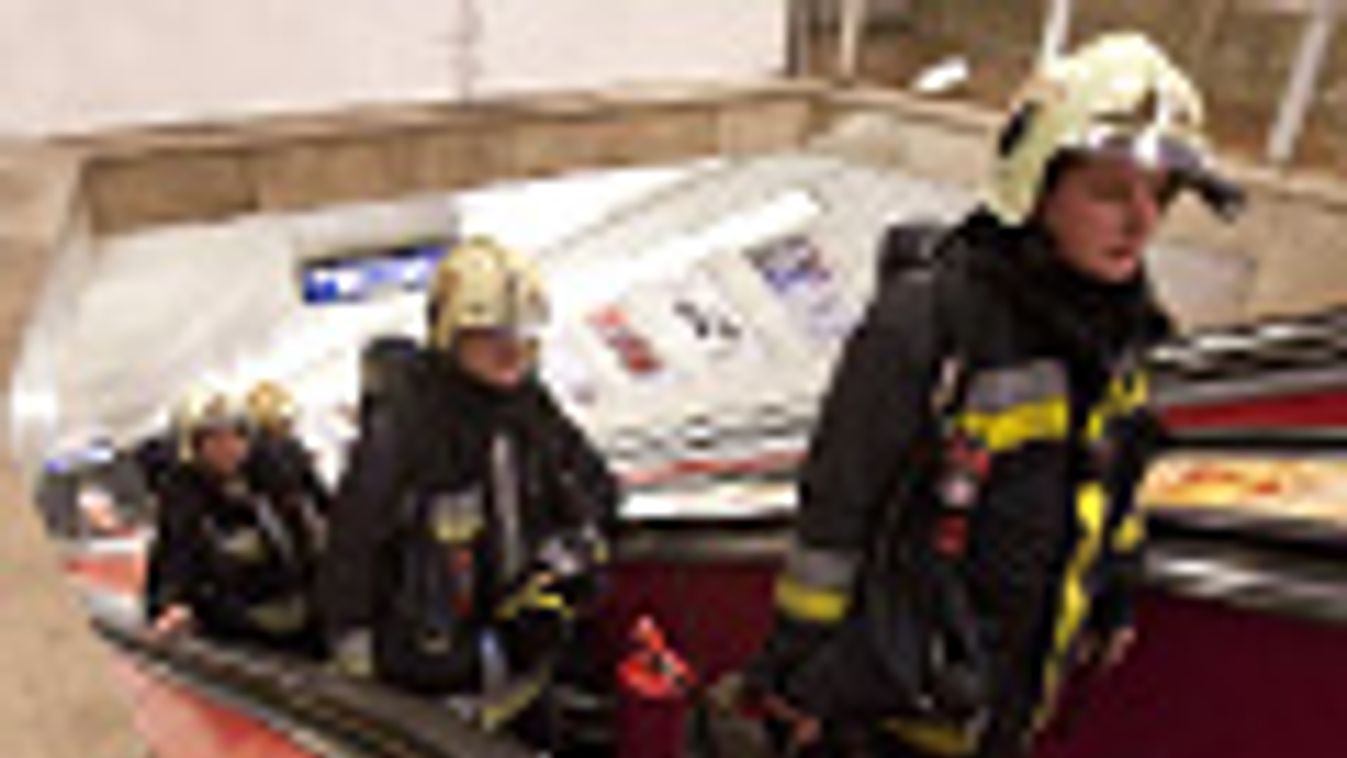 Tűzoltók jönnek fel a mozgólépcsőn a metró Deák téri állomásán, miután füst árasztotta el az alagutat 2011. december 9-én