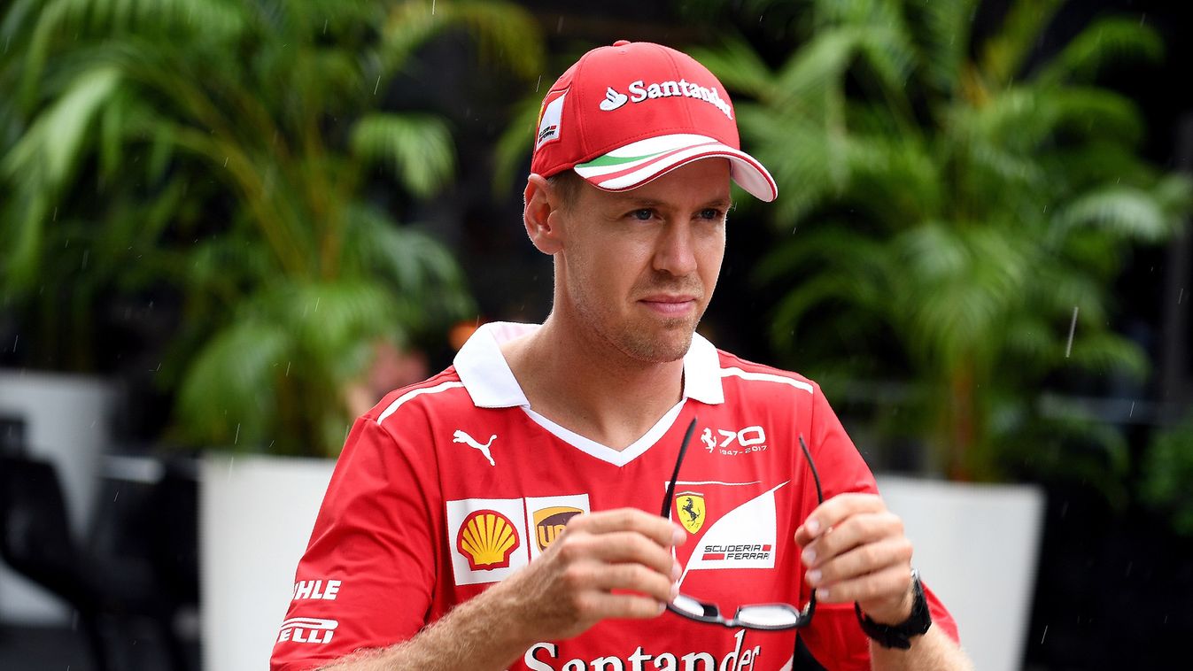 Horizontal Ferrari's German driver Sebastian Vettel walks in the paddock ahead of the Formula One Malaysia Grand Prix in Sepang on September 28, 2017. / AFP PHOTO / MANAN VATSYAYANA 