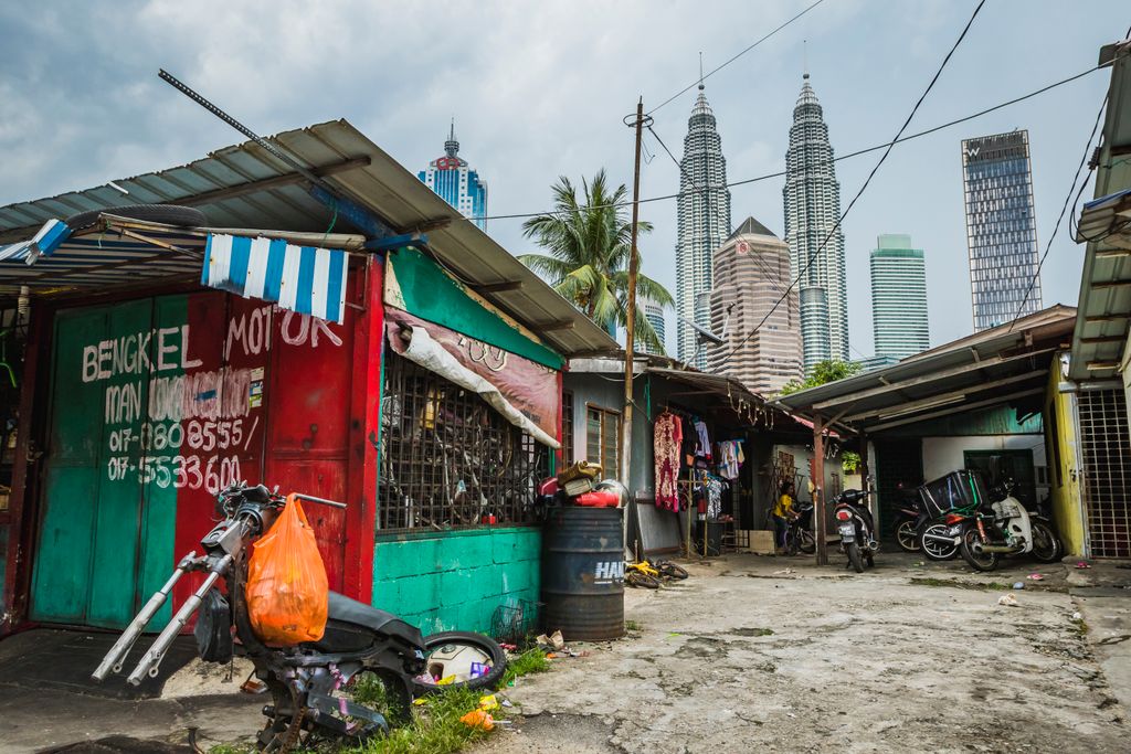 Side street in Kampung Baru with the Petronas Twin Towers in the background Kuala Lumpur