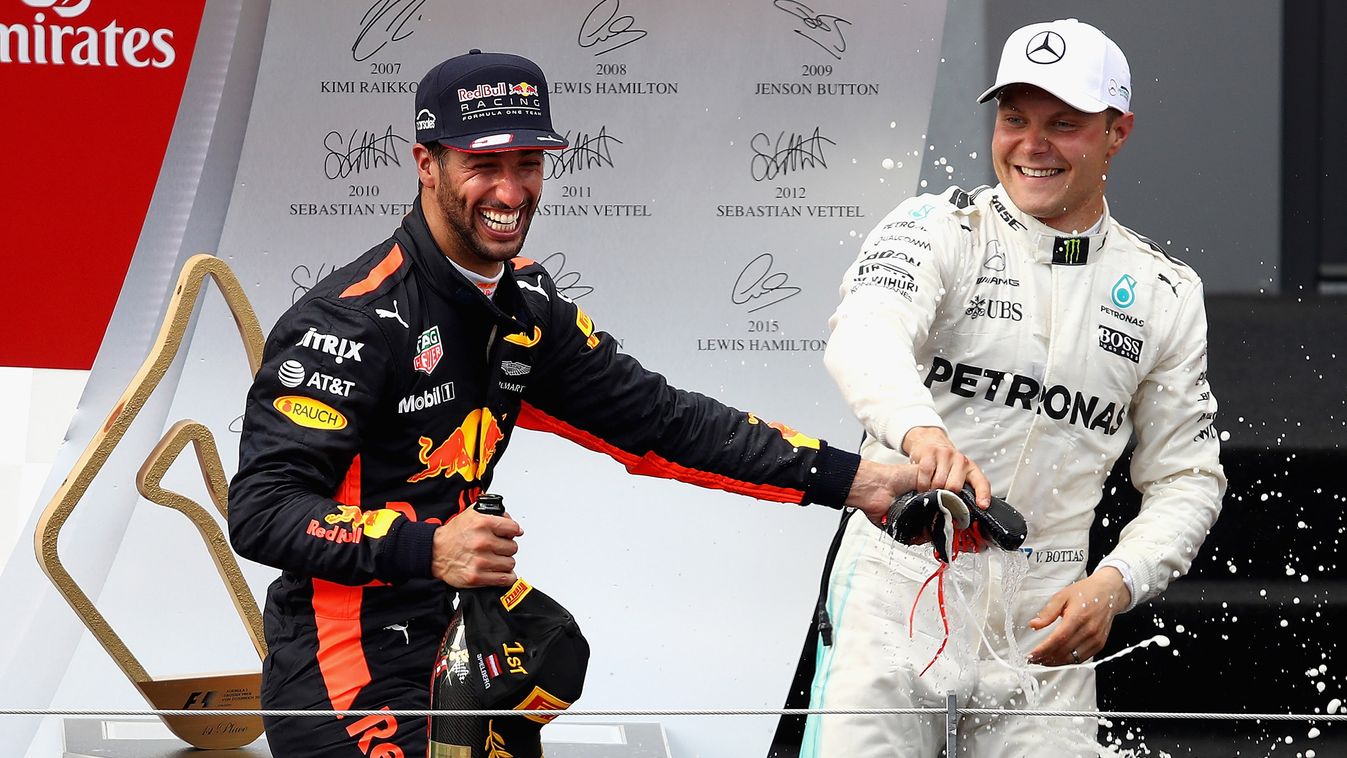 F1 Grand Prix of Austria P-20170709-04043 SPIELBERG, AUSTRIA - JULY 09:  Race winner Valtteri Bottas of Finland and Mercedes GP tries to avoid doing a shoey on the podium from Daniel Ricciardo of Australia and Red Bull Racing during the Formula One Grand 