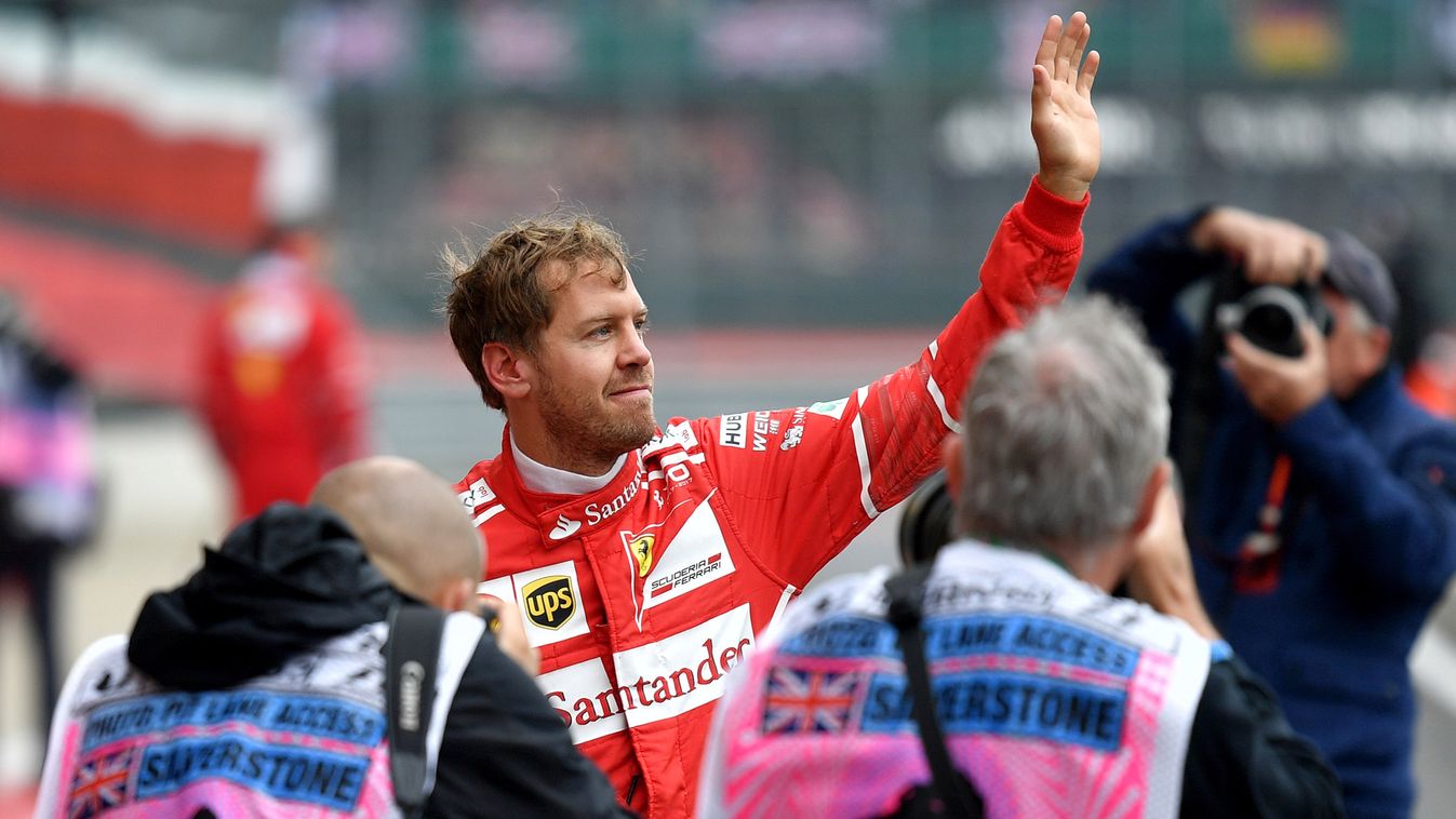 Horizontal Ferrari's German driver Sebastian Vettel waves to his supporters after the third practice session at the Silverstone motor racing circuit in Silverstone, central England on July 15, 2017 ahead of the British Formula One Grand Prix. / AFP PHOTO 