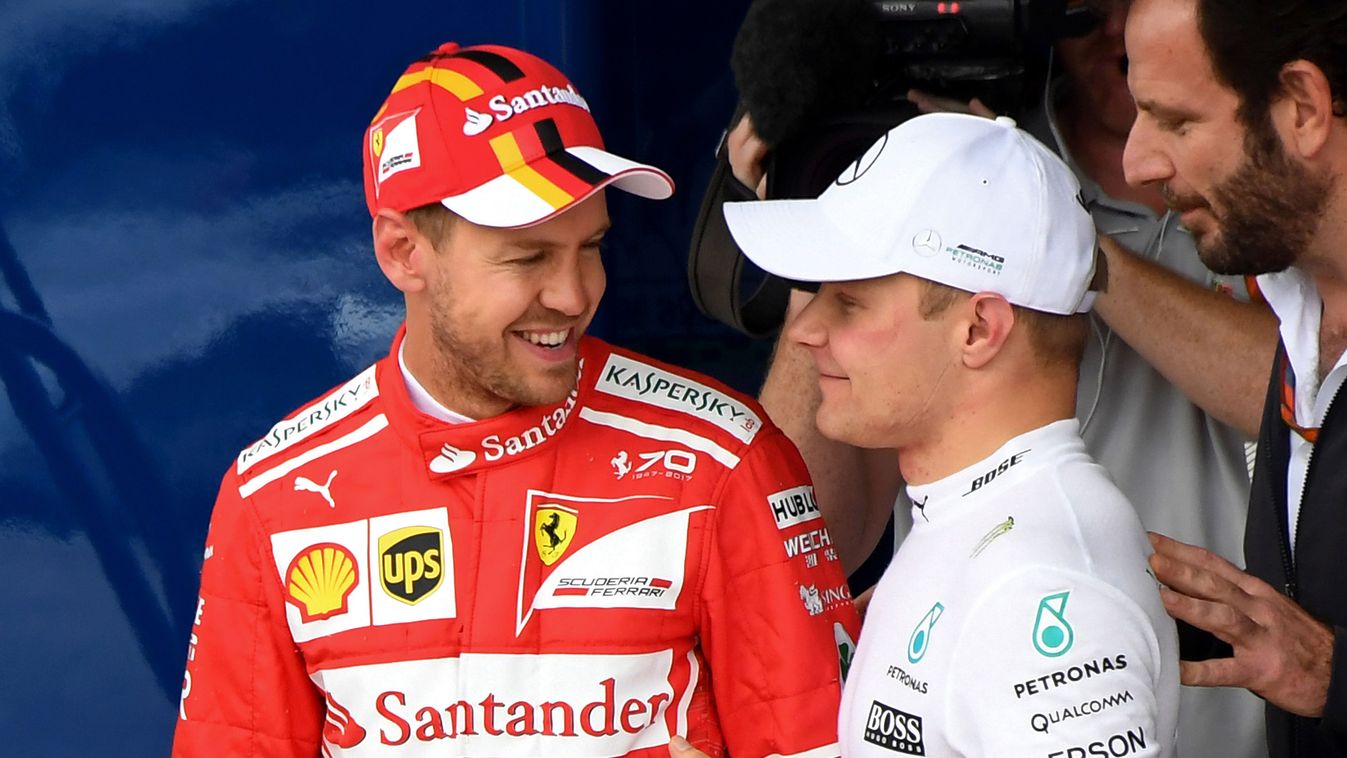 687715889 auto-f1 auto Horizontal Mercedes' Finnish driver Valtteri Bottas (R) and Ferrari's German driver Sebastian Vettel chat after taking the first and second place for the start of the Brazilian Formula One Grand Prix respectively, in the Q3 qualifyi