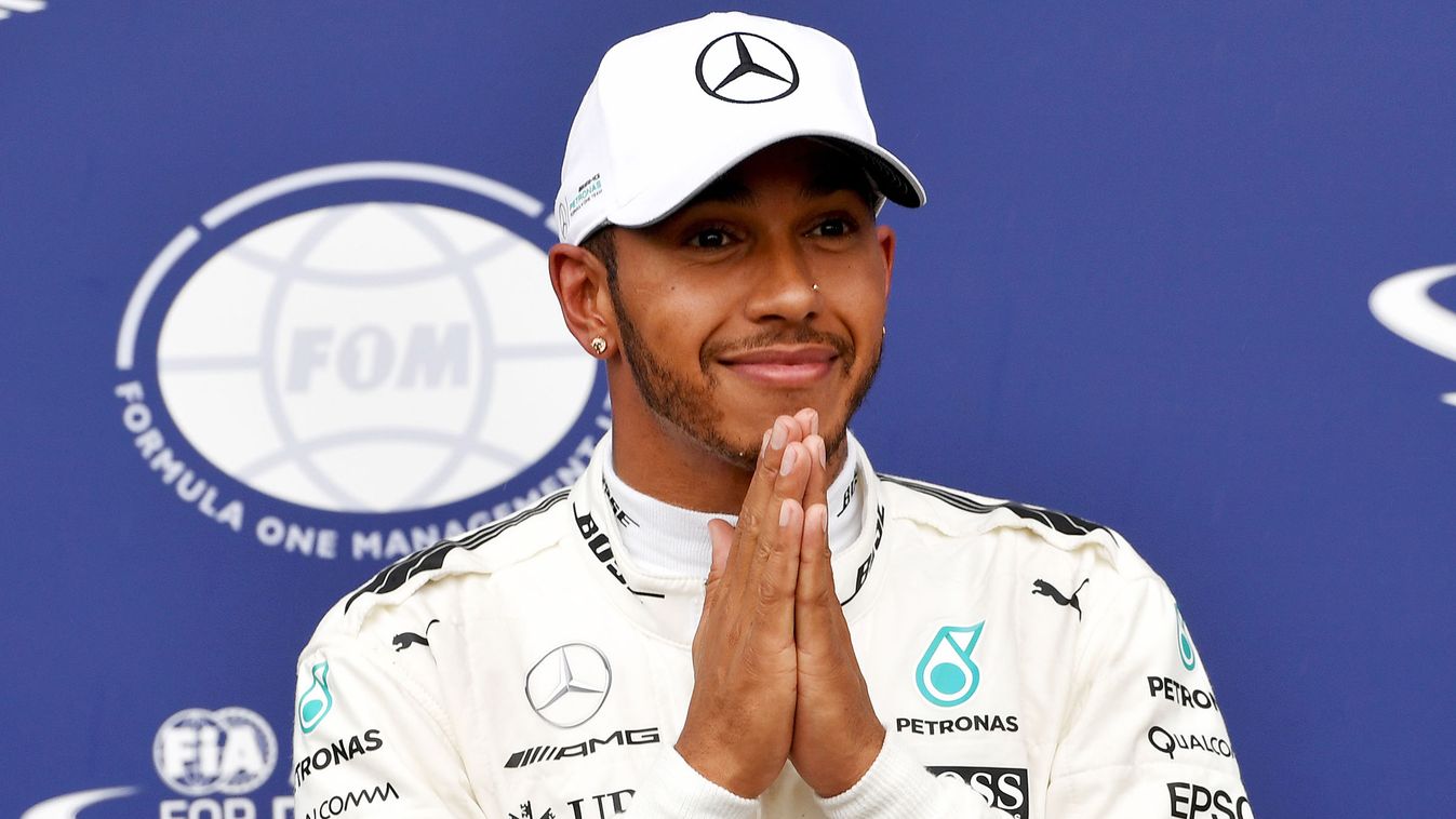 Horizontal Mercedes' British driver Lewis Hamilton celebrates winning the pole position after the qualifying session at the Autodromo Nazionale circuit in Monza on September 2, 2017 ahead of the Italian Formula One Grand Prix. / AFP PHOTO / ANDREJ ISAKOVI