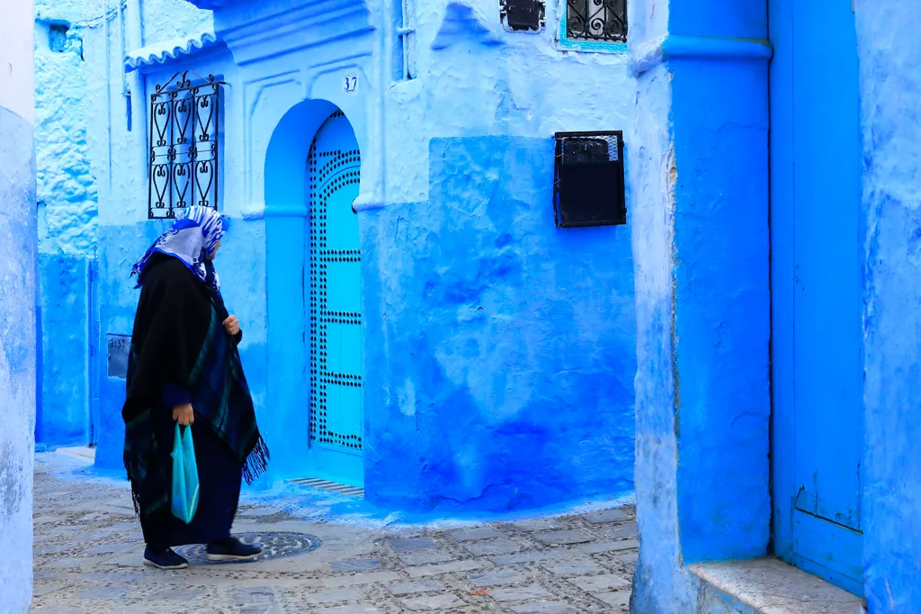 Morocco rif region chefchaouen medina woman going to market