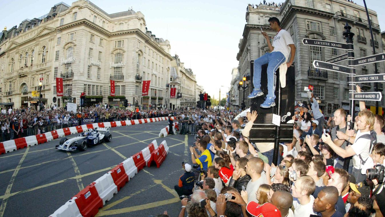 BRITAIN-F1-EVENT01 Horizontal People gather to see F1 drivers take laps of Regent Street in London 06 July 2004. The busy street normally filled with shoppers was blocked off for the F1 display ahead of the Grand Prix race at Silverstone, U.K.    AFP PHOT