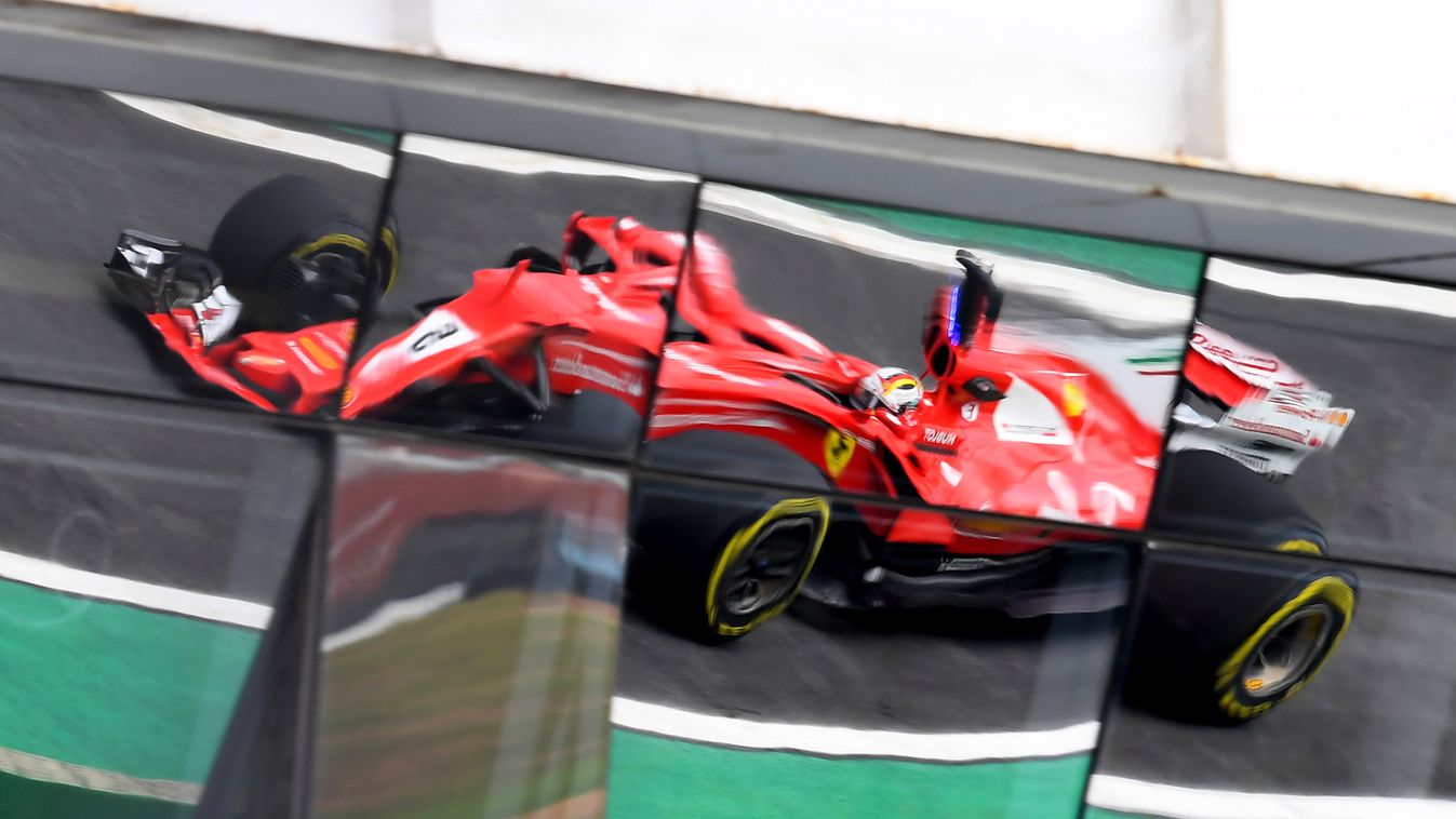 687715231 Horizontal Reflex of Ferrari's German driver Sebastian Vettel car, during the Brazilian Formula One Grand Prix practice session, at the Interlagos circuit in Sao Paulo, Brazil on November 10, 2017. 
 / AFP PHOTO / EVARISTO SA 